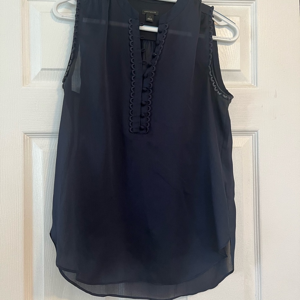 Pretty navy sleeveless blouse. Sheer. Button placket.